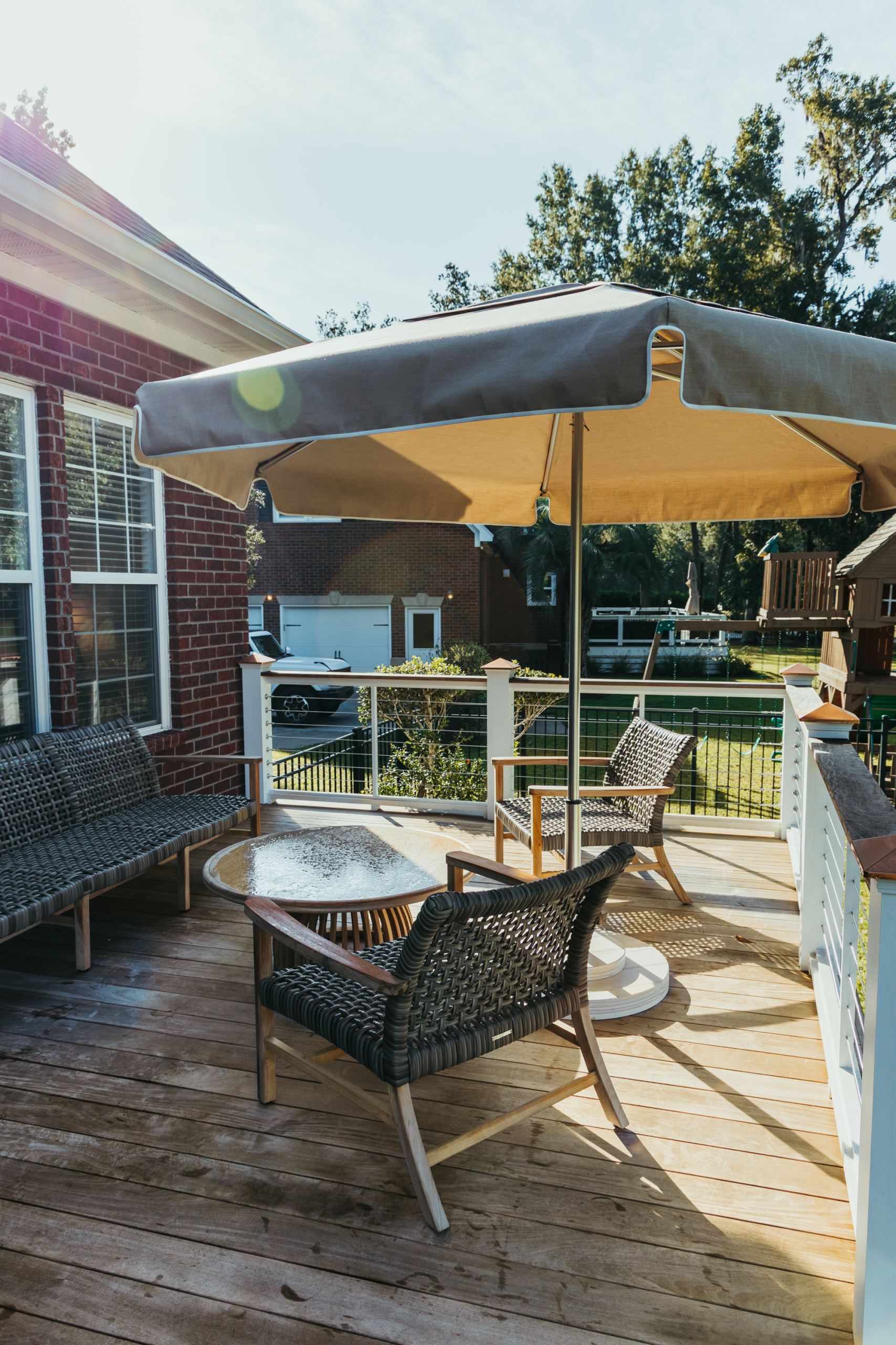 A Tresco Linen Palmetto Umbrella accenting a customer’s existing patio furniture