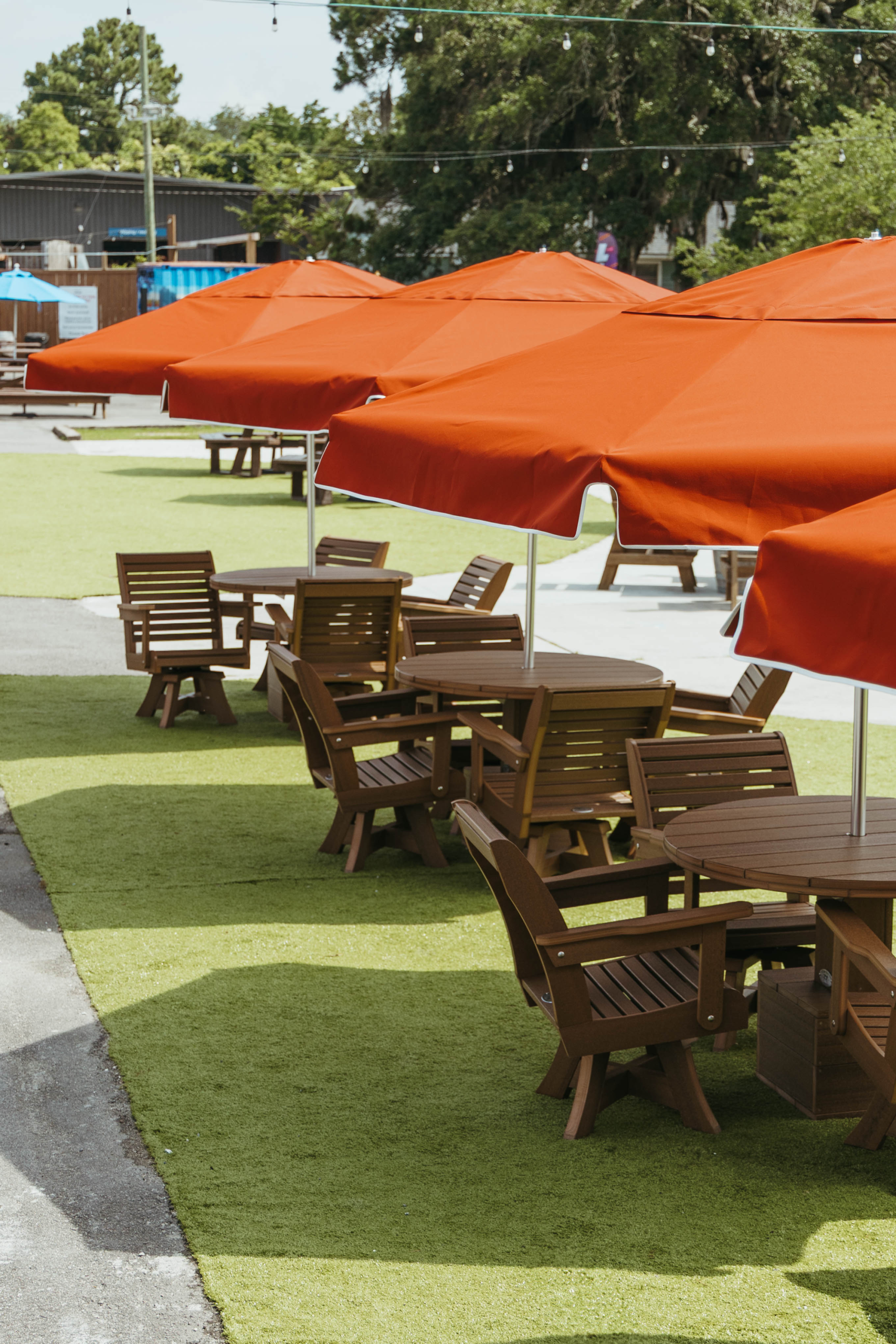 Multiple Terracotta Umbrellas sit above full tablesets