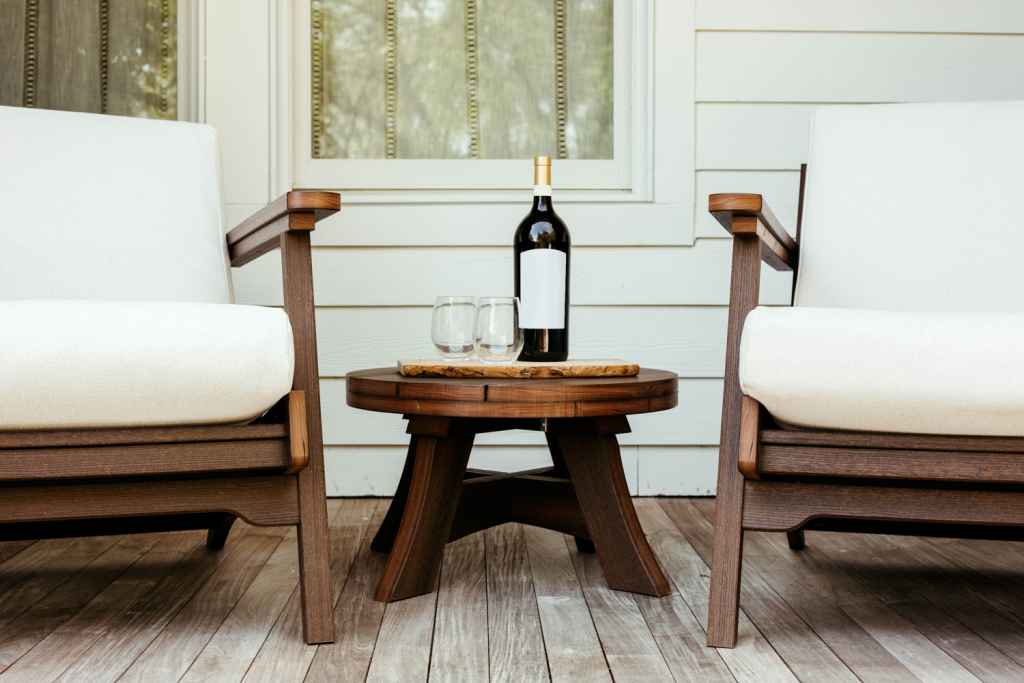 Two Bourbon chairs with a wine bottle between them — a simple, timeless patio furniture setup.