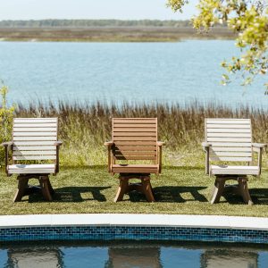 Three Low Tide Chairs poolside in a row, showing variations of color options. 
