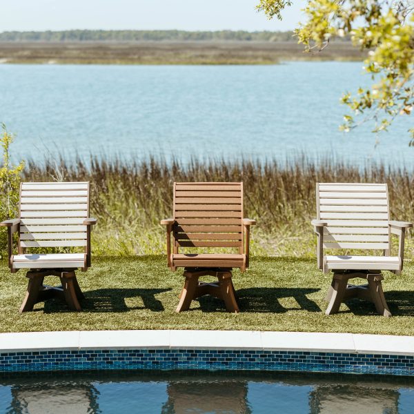 Three Low Tide Chairs poolside in a row, showing variations of color options. 