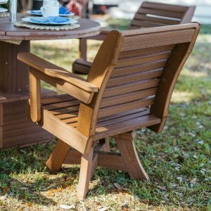 Mahogany Low Tide Chair sits on lawn, back exposed to show wood grain quality. 