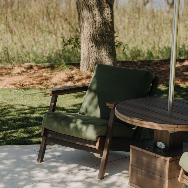 Low Tide Outdoor Lounge Table accents a Mahogany and Fern Bourbon Chair. 