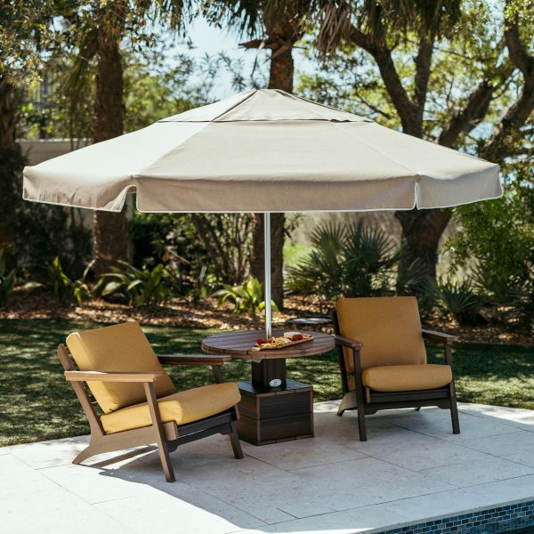 Palmetto Low Tide Patio Package with Brazilian walnut poly table, two Bourbon Chairs, and a Sunbrella® Tresco Linen canopy.