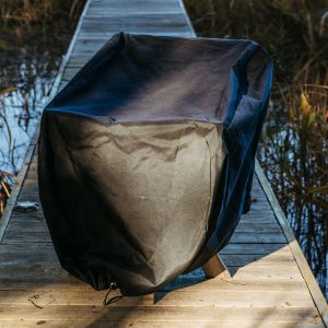 Black Single Seat Outdoor Chair Cover on a Low Tide Chair positioned on a dock in the sunset.