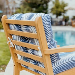 Sweetgrass Chair in Natural Teak, featuring Clock Out Indigo Sunbrella® cushions.