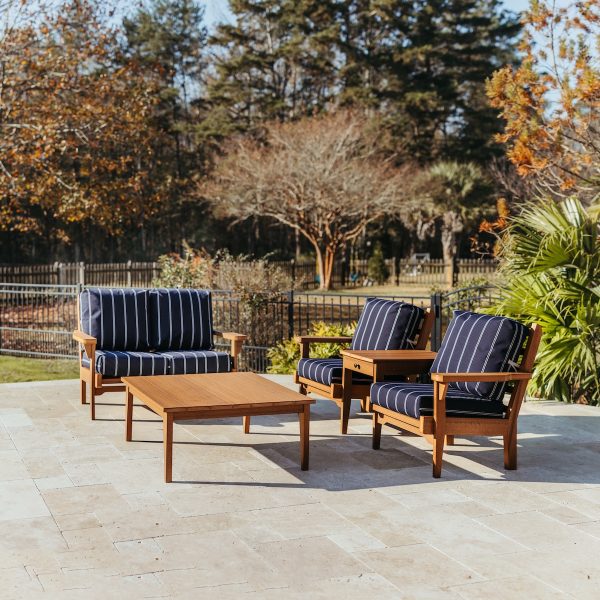 The Sweetgrass Gather Package in Antique Mahogany and Cooper Navy Cushions featuring the Sweetgrass Duo with center table, Sweetgrass loveseat, and Sweetgrass coffee table.